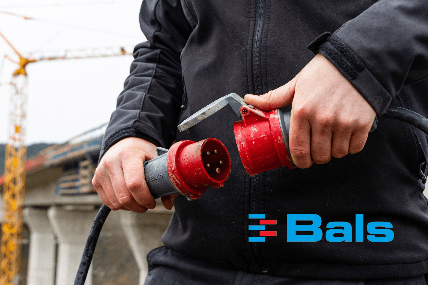 Man plugs in an INNOLINQ plug into a receptacle at a construction site