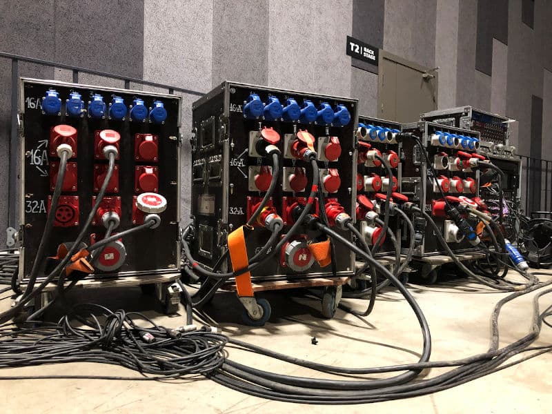 Piles of cables against the backdrop of a backstage area