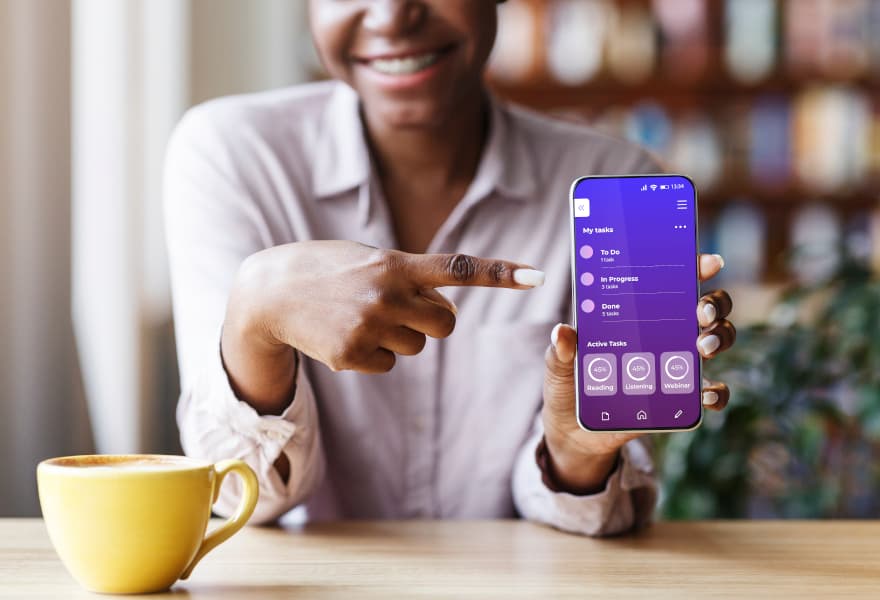 women points at her smartphone screen